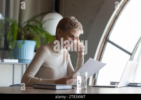 Happy confident business woman, professional, assistant, reading documents Stock Photo