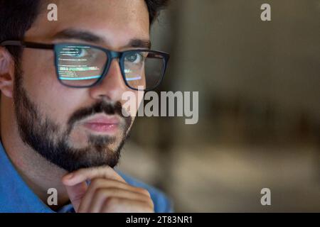 Business man wearing glasses with reflection using computer developing code. Stock Photo