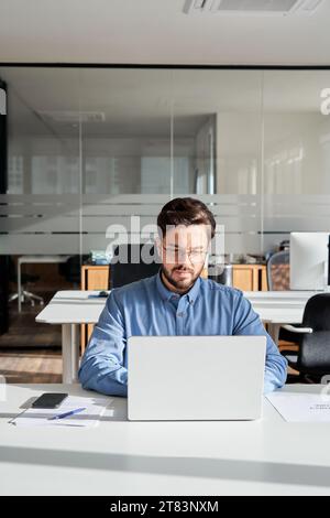 Busy professional businessman using laptop working on computer in office. Stock Photo