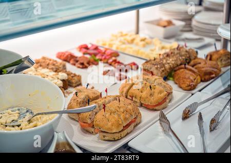 Assorted selection buffet of bread, dessert and salad on pastry counter at the hotel Stock Photo