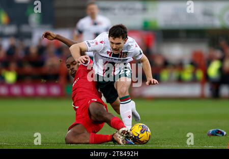 Wrexham's Thomas O'Connor (right) loses a boot as he is tackled by Accrington Stanley's Korede Adedoyin during the Sky Bet League Two match at the Wham Stadium, Accrington. Picture date: Saturday November 18, 2023. Stock Photo