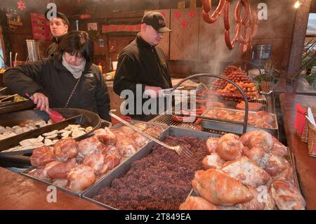 Hot pierogi and meat at food stand at street fair in Christmas season on Main Market Square in Krakow, Poland Stock Photo