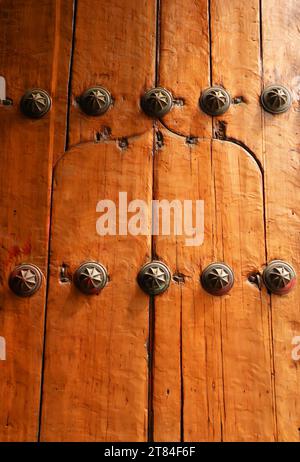 Old wooden door with iron rivets Stock Photo