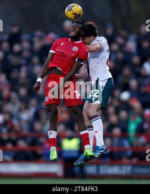 Accrington Stanley's Rosaire Longelo (left) and Wrexham's Thomas O'Connor battle for the ball during the Sky Bet League Two match at the Wham Stadium, Accrington. Picture date: Saturday November 18, 2023. Stock Photo