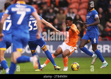 Blackpool's Karamoko Dembélé (right) is fouled by Shrewsbury Town's Tom Flanagan (left) and wins a penalty during the Sky Bet League One match at Bloomfield Road, Blackpool. Picture date: Saturday November 18, 2023. Stock Photo