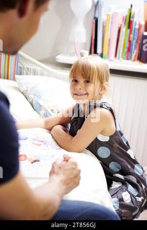 Father, daughter and coloring book on bed or happiness with bonding, creativity and relationship in home. Family, man and girl kid or artistic in Stock Photo