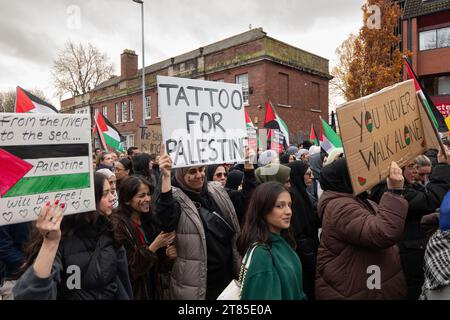 From the river to the sea, Tattoo for Palestine and You never walk alone signs at Palestinian protest in central Manchester. UK. Over a thousand protesters gathered at Whitworth Park calling for a ceasefire. They then marched past Manchester University along Oxford Rd to the city centre. Police guarded outlets that the protesters said had links with Israel including McDonalds and Fisher Geram. The march finished at Manchester cathedral where some protestsers mounted the cathedral balustrade and waved flags. Manchester UK. Picture: garyroberts/worldwidefeatures.com Stock Photo