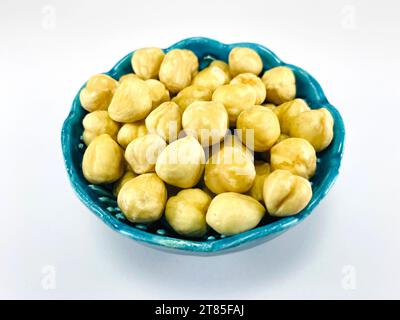Hazelnut. Hazelnut health organic filbert white background concept. Hazelnut in blue bowl Stock Photo