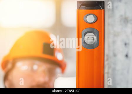 Acceptance of a new apartment by a professional receptionist using a level tool and other specialized tools Stock Photo