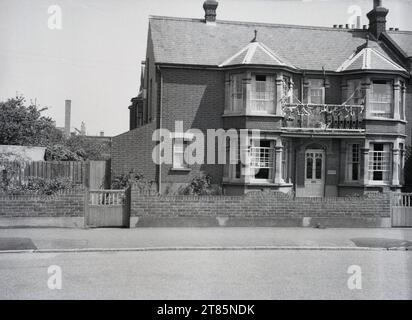 1950s, historical, exterior of a large end of terrace, late Victorian double-fonted house, with union jack bunting on balcony, England, UK, celebrating the Queens Coronation in 1953. Stock Photo