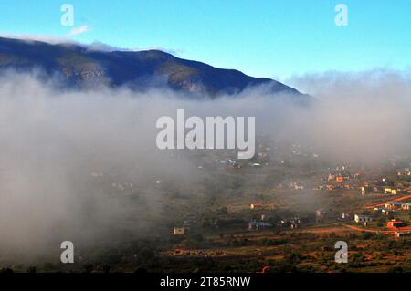 As the world battles climate change mist covers Maja village on the edges of the Drakensberg mountains in Limpopo, South Africa as weather patterns Stock Photo