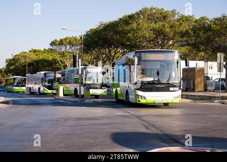 Valletta, Malta - 17 June 2023: In the Floriana district, green public service buses departing. Stock Photo