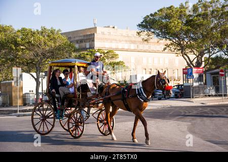 Valletta, Malta - 17 June 2023: Horse-drawn tourist carriage racing through the streets of the capital of Malta Stock Photo