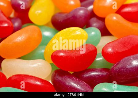 Close up of a mass of colourful jelly beans including red, orange, yellow, green and violet. Stock Photo