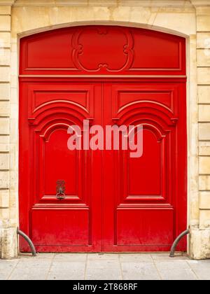 Red wooden entrance in Paris, France Stock Photo