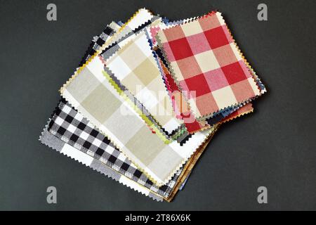 Checkered fabric pattern samples on black background, top view Stock Photo