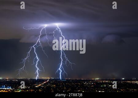 Powerful lightning strikes from a thunderstorm over Mesa, Arizona Stock Photo