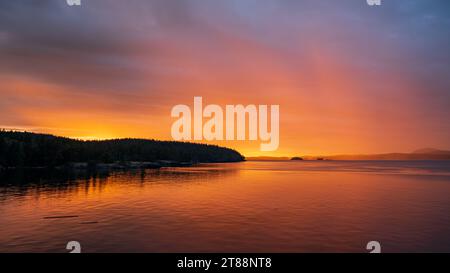 Beautiful sunset and rain in the distance from Salt Spring Island, British Columbia, Canada. Stock Photo
