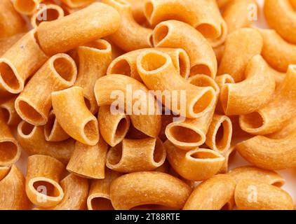 Background of Gluten Free Dry Brown Rice Elbow Macaroni Pasta Stock Photo