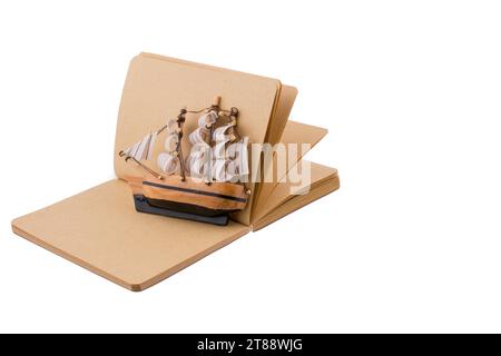 Old Ship on a notebook on a white background Stock Photo