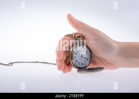 Hand holding a retro styled pocket watch in hand Stock Photo