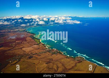 The Hawaiian island of Kauai, as seen from an island-hopping airplane. Fluffy white clouds contrast with the turquoise waters of the Pacific Ocean. High quality photo Stock Photo