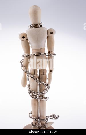 Wooden model man in chains on a white background Stock Photo - Alamy