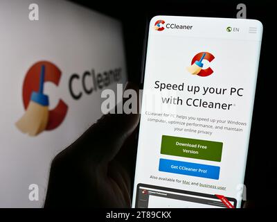 Person holding smartphone with webpage of computer system clearning software CCleaner in front of logo. Focus on center of phone display. Stock Photo