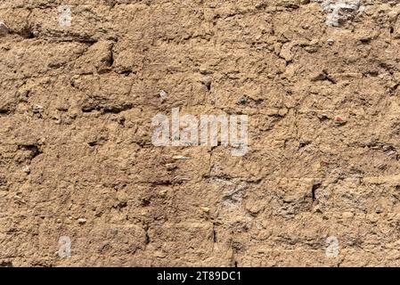 Background of brick wall covered with clay Stock Photo