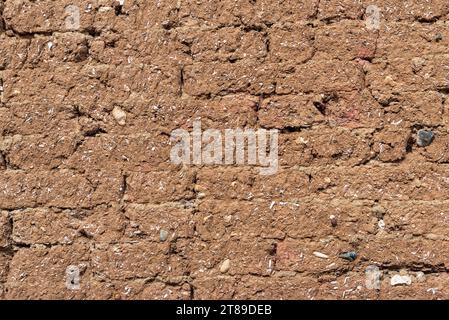 Background of brick wall covered with clay Stock Photo