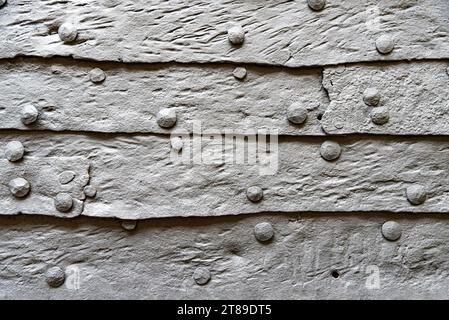 Wrought iron sheet surface with metal rivets Stock Photo
