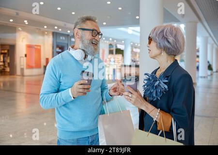 Retired people spending time in city shopping center Stock Photo
