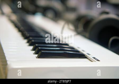 Close up of an electronic piano keyboard with headphones Stock Photo