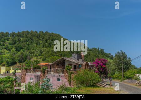 Santa Antao, Cape Verde - October 10.2023: A restaurant in the volcanic mountains surrounding with trees on Santo Antao Island Stock Photo
