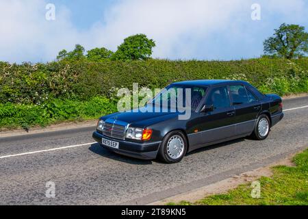 1992 90s nineties Mercedes 260E Petrol 2590 cc, fuel injection engine, four-door sedan; Vintage, restored German classic motors, automobile collectors,  motoring enthusiasts and historic veteran cars travelling in Cheshire, UK Stock Photo