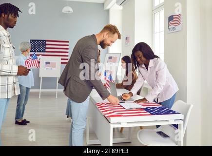 Diverse American citizens come to vote at polling station on election day in USA Stock Photo
