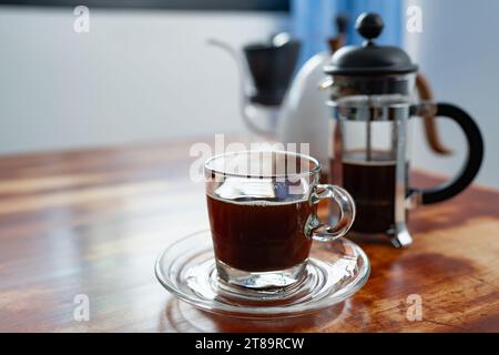 Arabic coffee beans bottom of the french press and cooked caffe inside the  glass side of the press and wooded details with dull yellow background  Stock Photo - Alamy