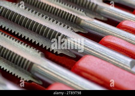 Set of thread taps, industrial metalworking tools, close-up shot, shallow depth of field Stock Photo