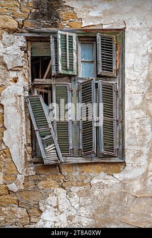 Old broken window with wooden shutters. Buffer zone. Nicosia. Cyprus. Stock Photo