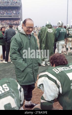 Sports medicine pioneer Dr. James Nicholas talks to NFL defensive lineman Carl Barzilauskas on the sidelines during a game at Shea Stadium in 1978, in Flushing, Queens, New York. He was the team orthopedic doctor. Stock Photo