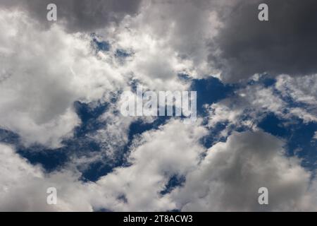 overcast sky, full-frame gray clouds with gaps of blue sky Stock Photo