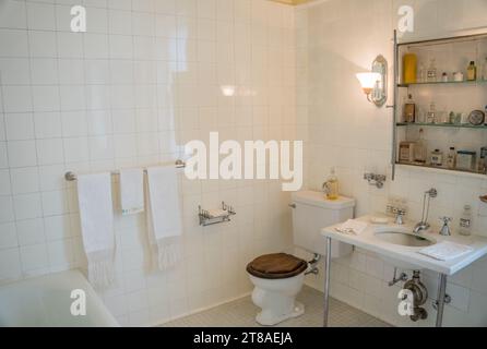 Old fashioned bathroom with white-tiled walls. Stock Photo