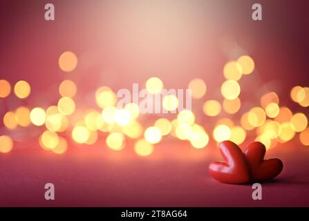 Two red valentines plastic hearts on red background. Stock Photo