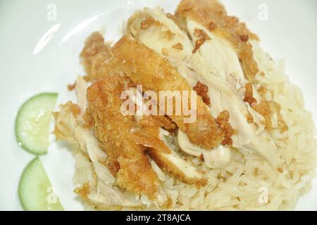 steamed rice topping chop crispy fried  chicken on plate with chili sauce and soup Stock Photo