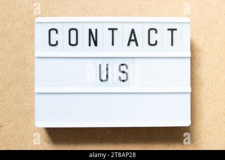 Lightbox with word contact us on wood background Stock Photo