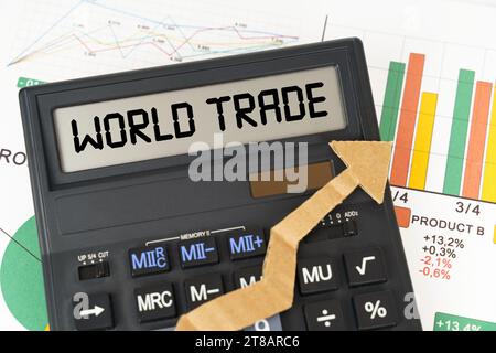 Business concept. On the business charts there is a calculator on the screen with the inscription - World Trade Stock Photo