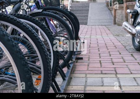 parking with bicycles on the street, at the entrance to the store. Close-up of the wheel . High quality photo Stock Photo