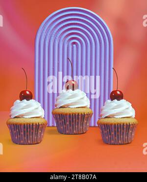 Trio of Whipped Cream Frosted Cupcakes with Vibrant Orange and Purple Background - Bakery Menu Highlights Stock Photo