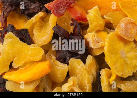 Mix of dried exotic fruit, mangos,slices of pineapples, passion fruit, papaya. Vegetarian dessert. Stock Photo