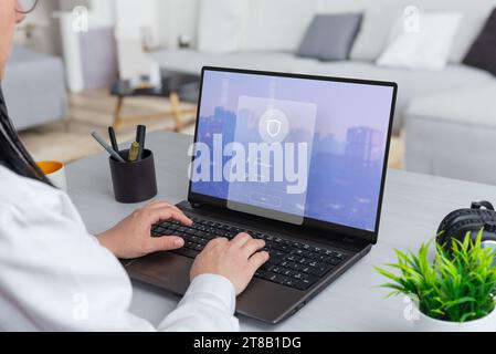 Woman working on a laptop, featuring a security login form hovering above. Merge productivity with the assurance of digital security Stock Photo